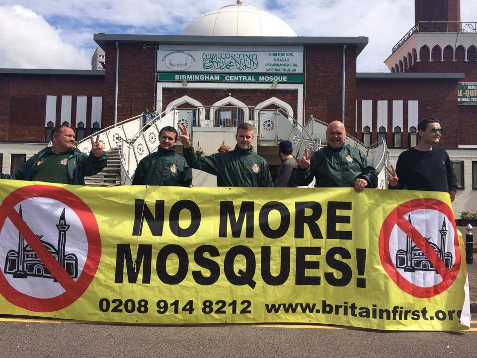 Far-right hate group Britain First unfurl a 'No More Mosques' banners outside Birmingham Central Mosque in August 2014