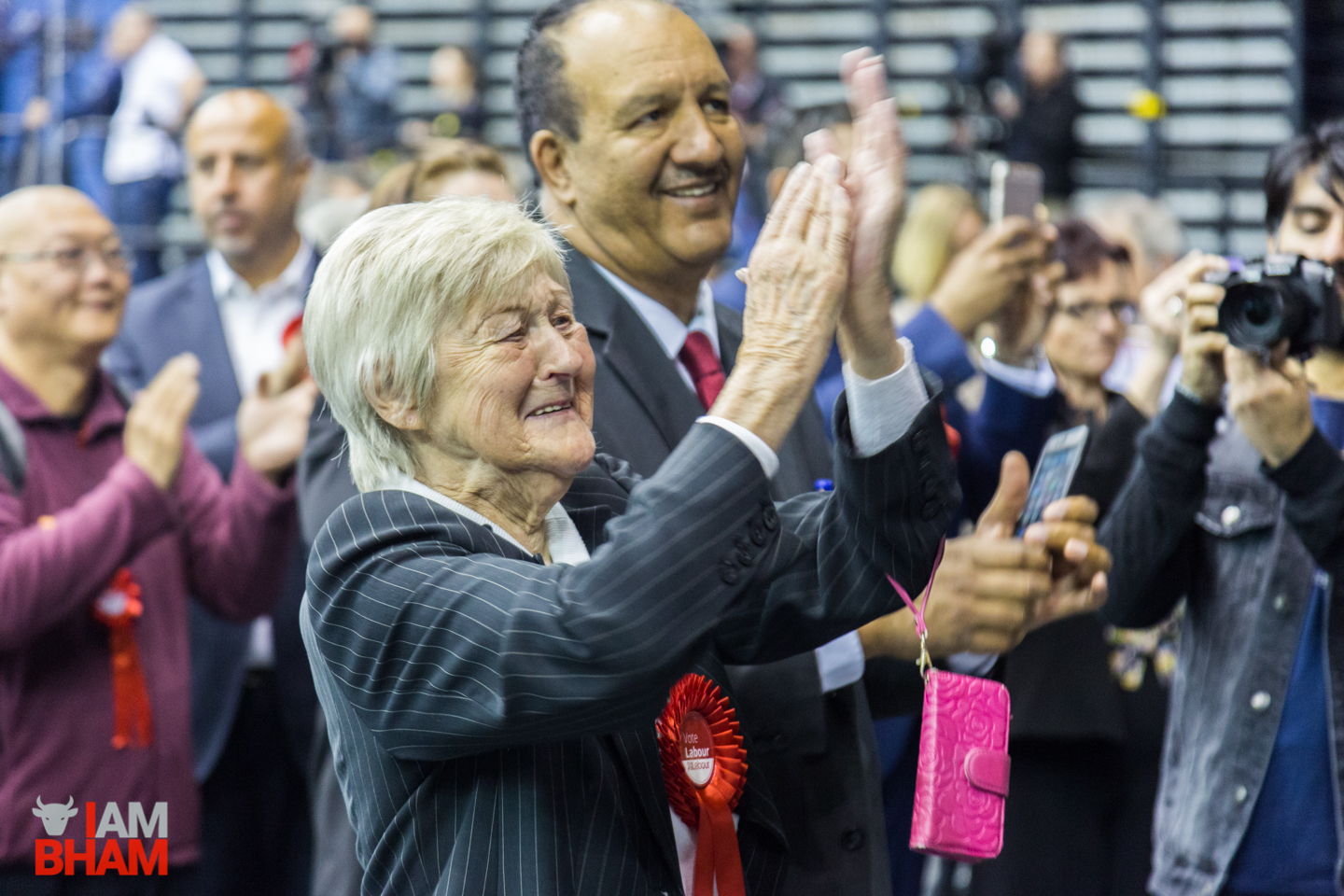 A Labour supporter applauds the Birmingham results for the first round of the West Midlands Mayoral Election