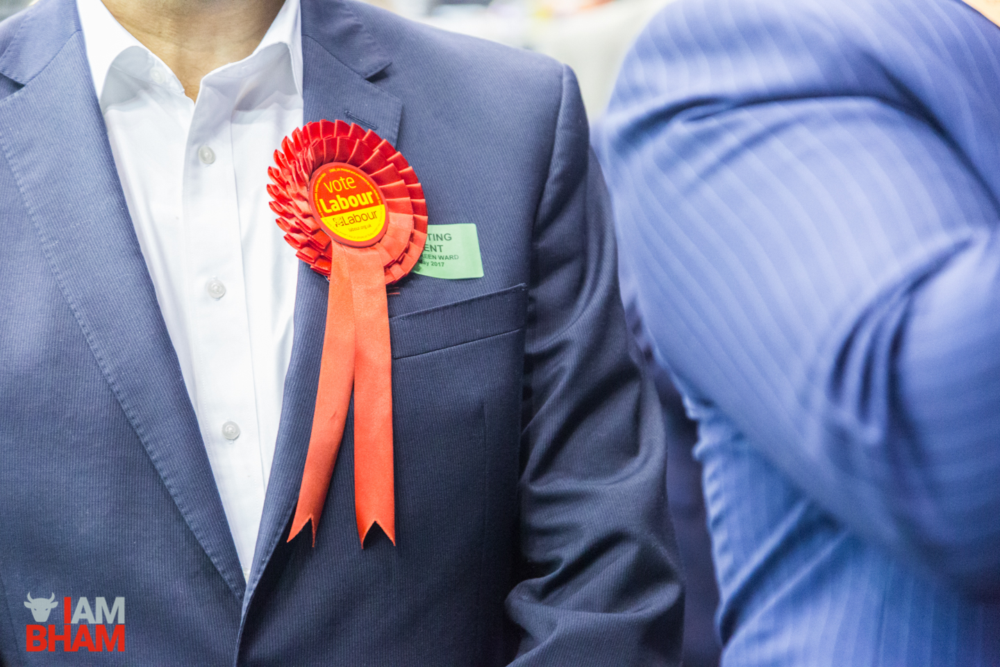 A red Labour Party rosette at the West Midlands Mayoral Election vote count in Birmingham
