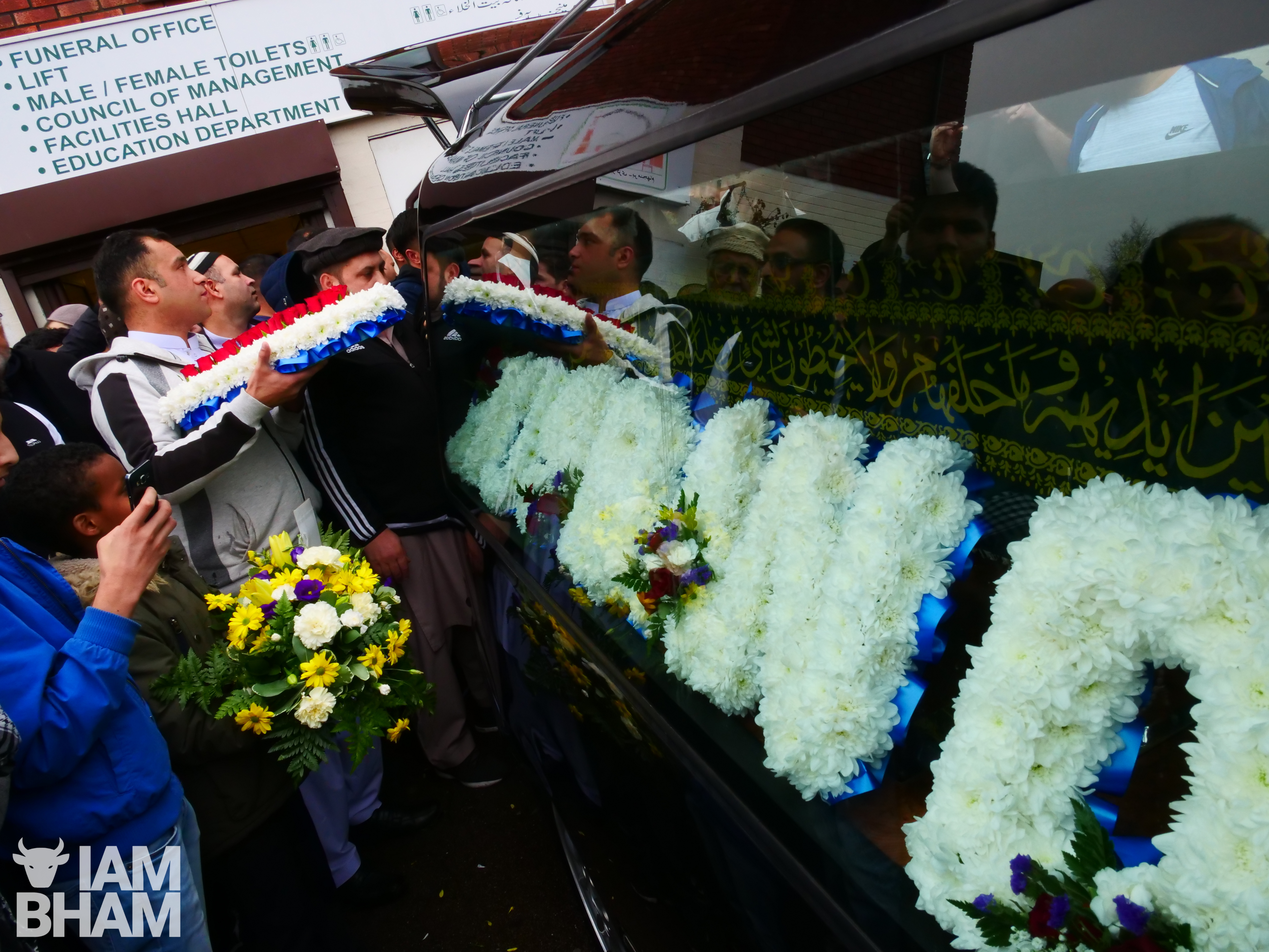 Flowers bearing the message 'Father' were placed in the hearse alongside the coffin containing Imtiaz Mohammed's body