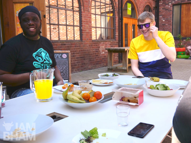 Young creatives Daniel J. Blyden (left) and Daniel Zastwany enjoying a spot of lunch outdoors at the Impact Hub in Birmingham
