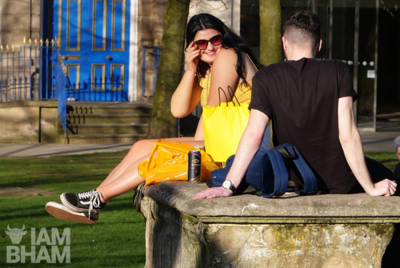 A young couple enjoying the sun in Birmingham's Cathedral Square