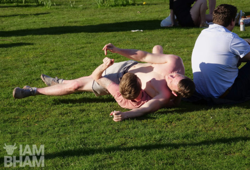 Two lads having a playful tussle in Pigeon Park (Cathedral Square) in Birmingham