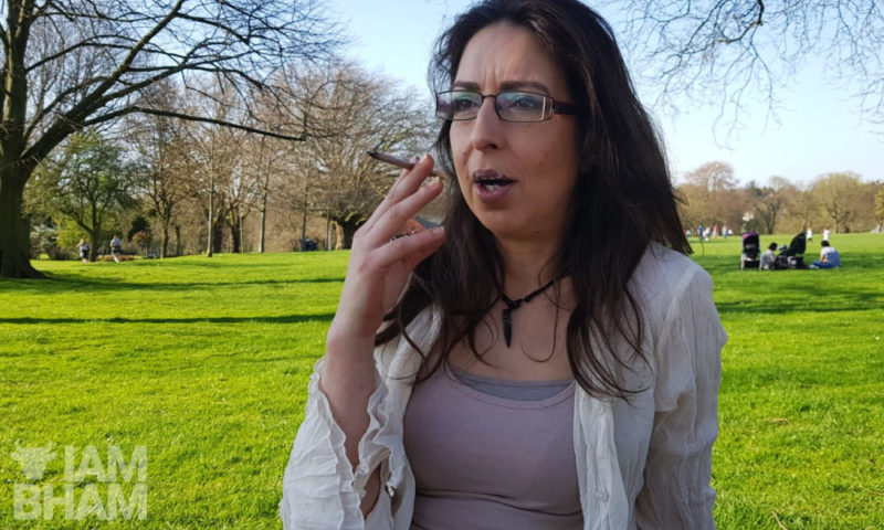 Aysha having a smoke in the sun in Handsworth Park