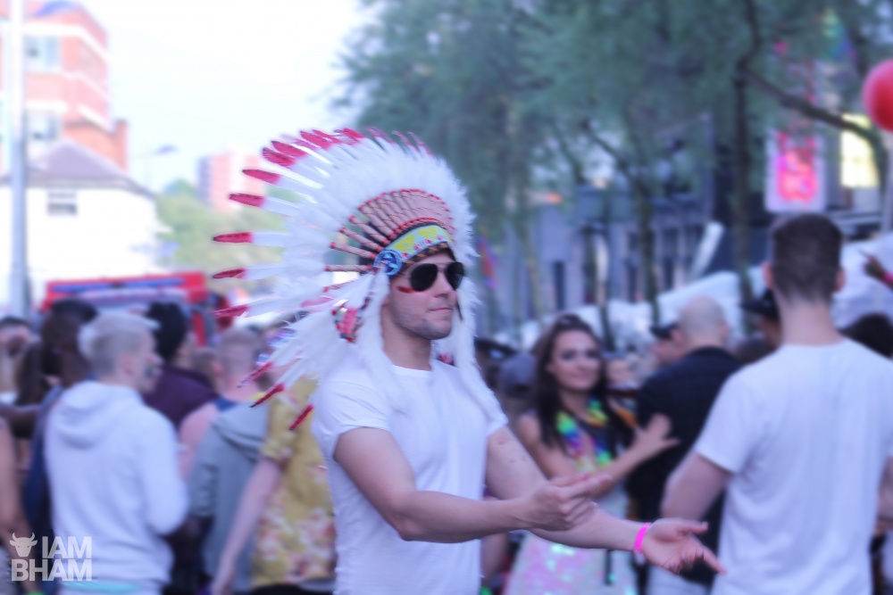 A white Birmingham Pride attendee swaggering along Hurst St this weekend, in a Native American War Bonnet