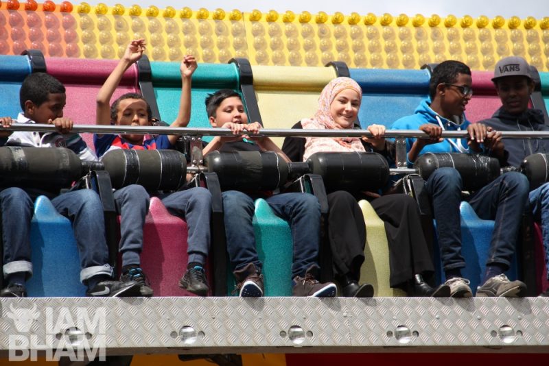 Youn people enjoying the fairground rides at 'Celebrate Eid' in Small Heath Park, Birmingham