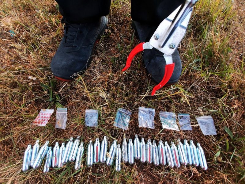 Nitrous oxide canisters and empty resealable cannabis micro bags recovered in a park cleanup
