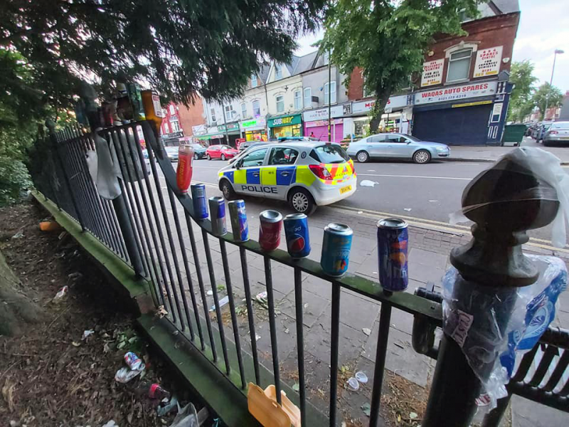 The railings of Small Heath park 'decorated' by used cans and bottles