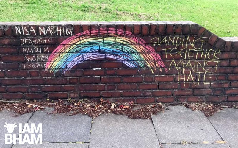 The rainbow and messages of peace painted on the wall after the racist graffiti was removed 