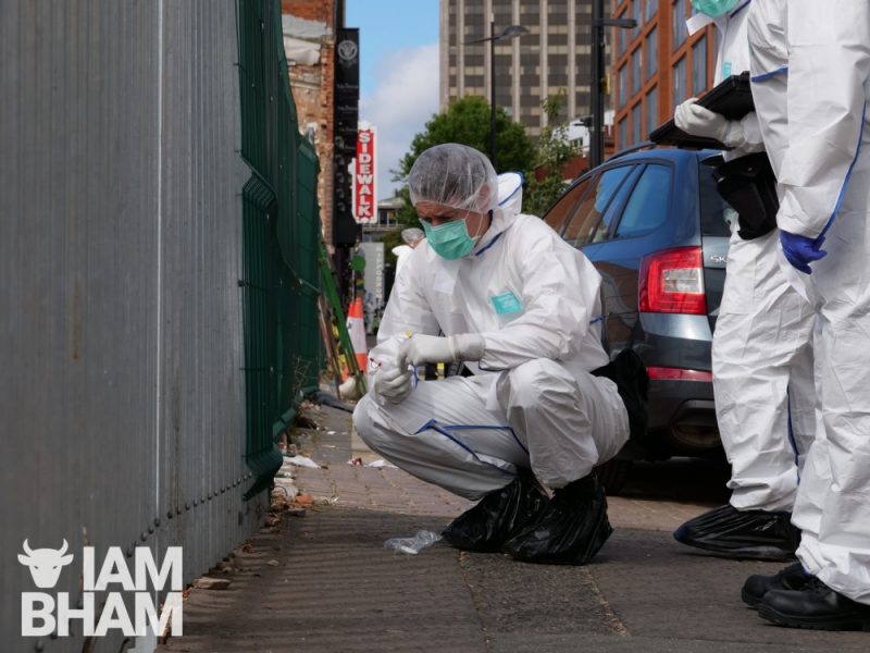 A police forensics scientist collects possible evidence from Hurst Street