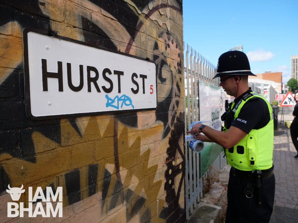 A West Midlands Police officer seals off Hurst Street as a murder investigation gets underway