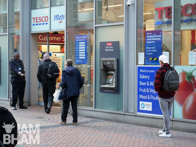 People queueing 2 metres apart outside Tesco supermarket in Birmingham city centre