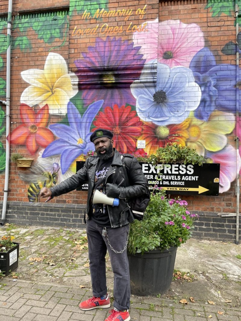 Artist Bunny Bread with a mural of flowers to remember the lives lost during the coronavirus pandemic