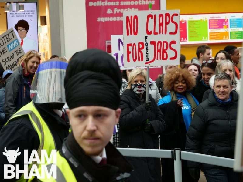 Security staff in Birmingham's Bullring shopping centre struggles to contain the anti-vaccination protest march 