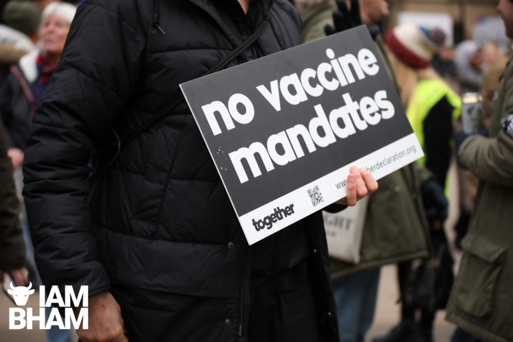 A protester displays a "No vaccine mandates" placard in Birmingham 