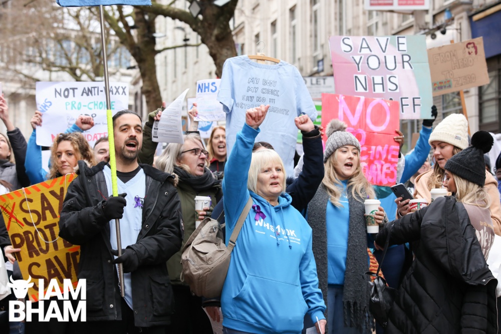 An anti NHS vaccine mandate march travels through Birmingham city centre as protesters chant "We Stand Together" 