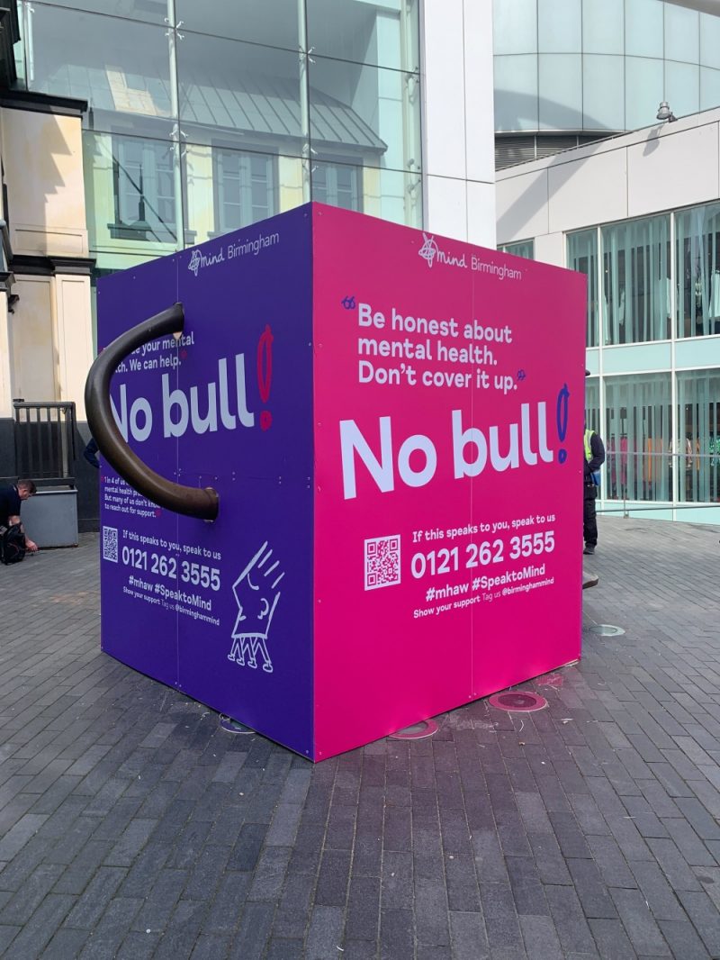 The iconic Bullring bull is encased in a box with details of mental health support