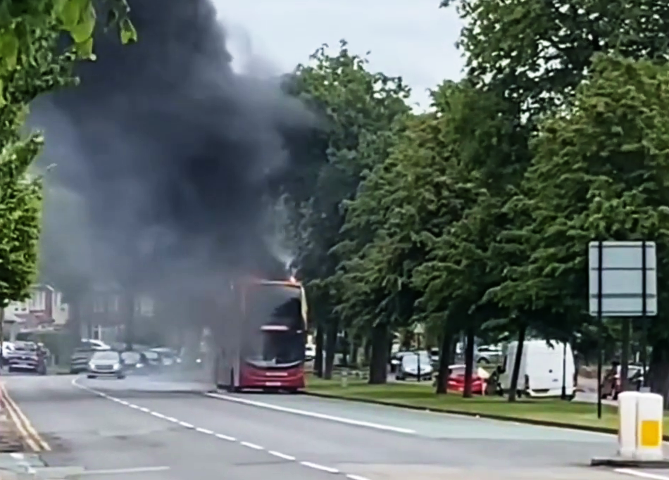 Plumes of smoke spiral out of the bus causing traffic issues for motorists