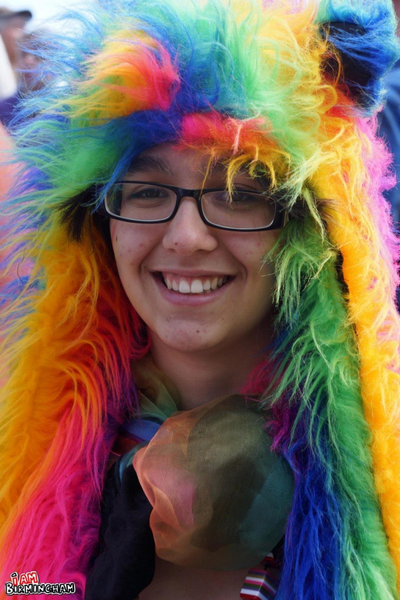 Smiling with a rainbow furry costume
