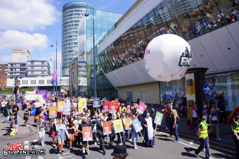 Pride marches past the Rotunda and Bullring in Birmingham
