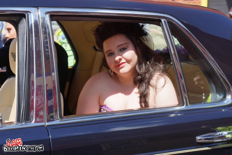 A woman smiles in a car during the Pride parade 