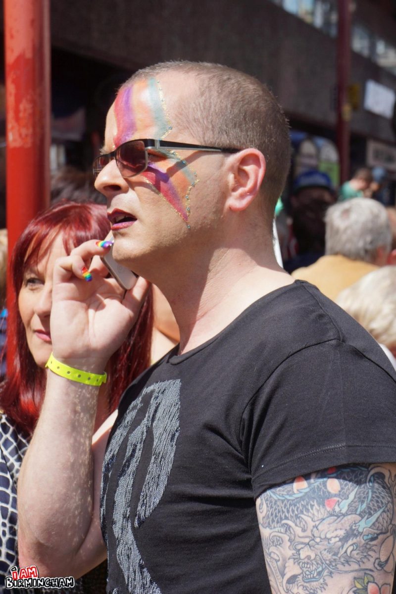 Man with rainbow face paint at Birmingham Pride 
