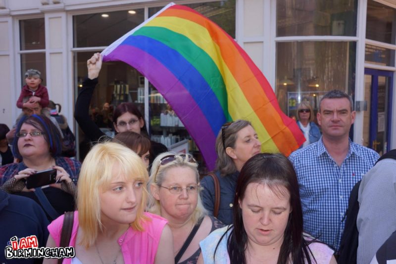 A man waves a rainbow Pride flag in Birmingham 