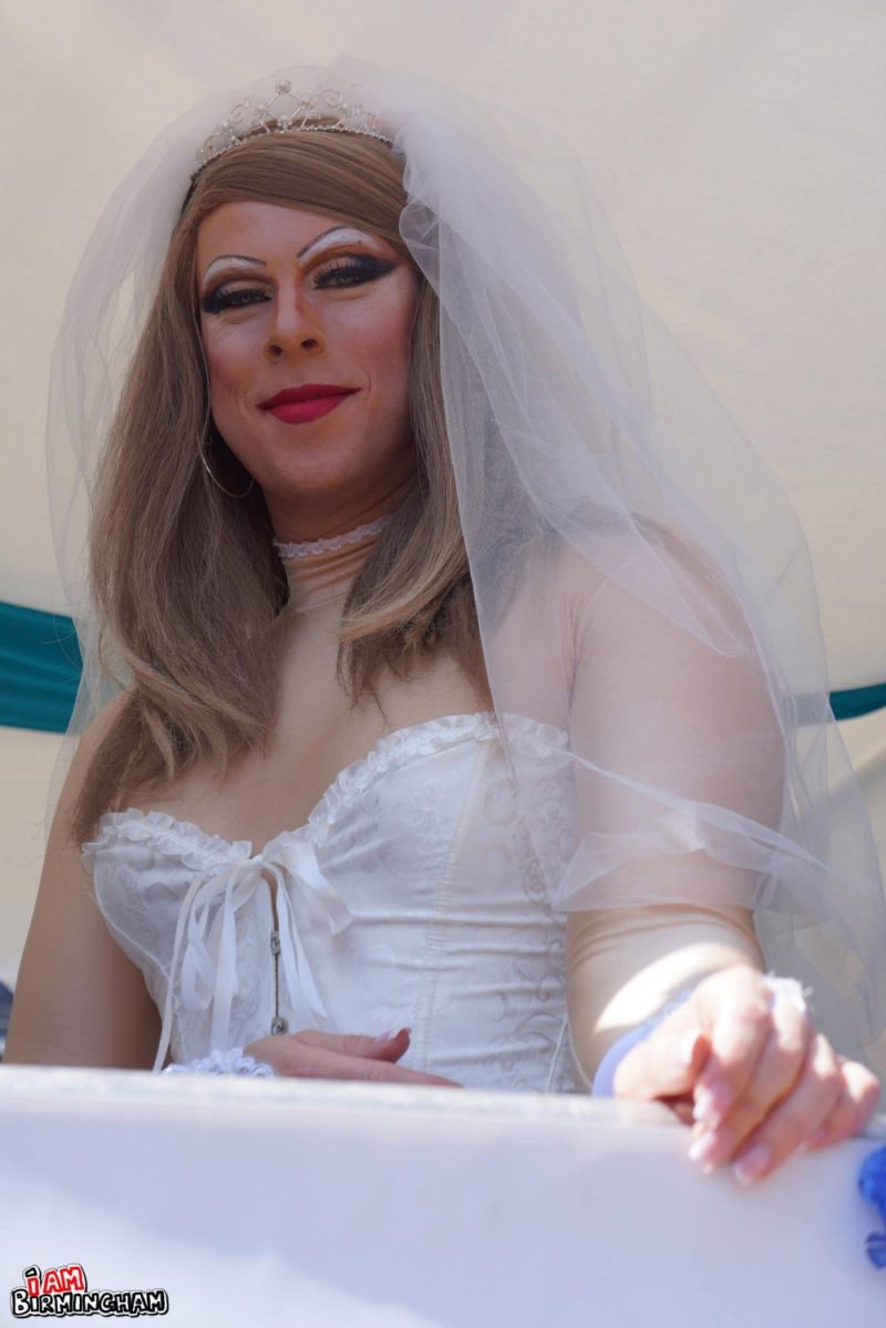 A Pride parade participant in a drag bride costume 