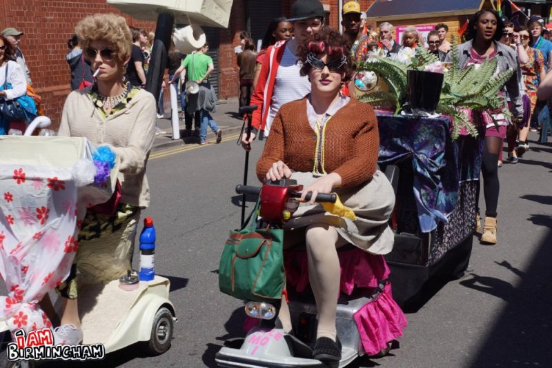 A group of drag artists on mobility scooters take part in the Pride parade 
