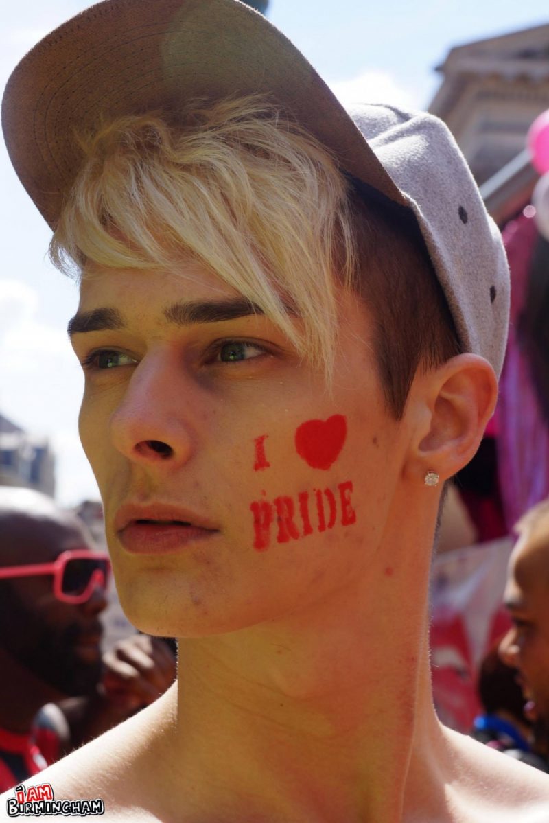 Young attendee with 'I Love Pride' face paint stamp 