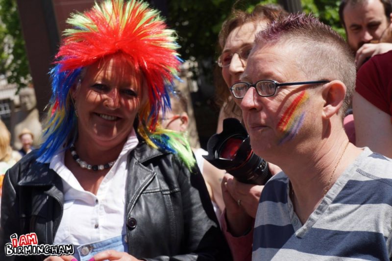 Revellers in Pride rainbows and wigs at Pride 