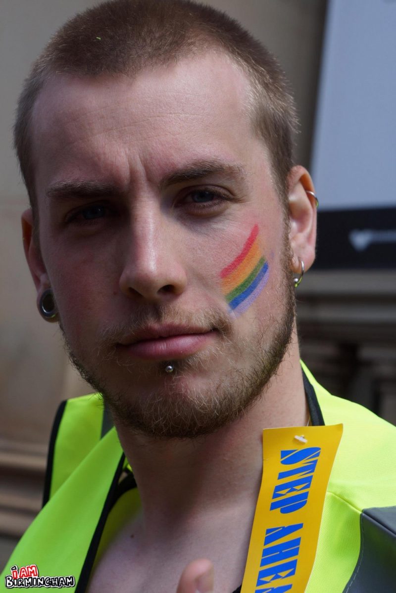 Guy with pride rainbow face paint