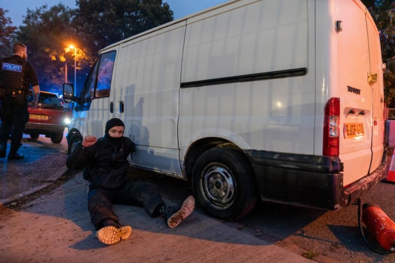 Activists tie themselves to vans blocking all entrances to the drone factory reportedly owned by Elbit Systems 