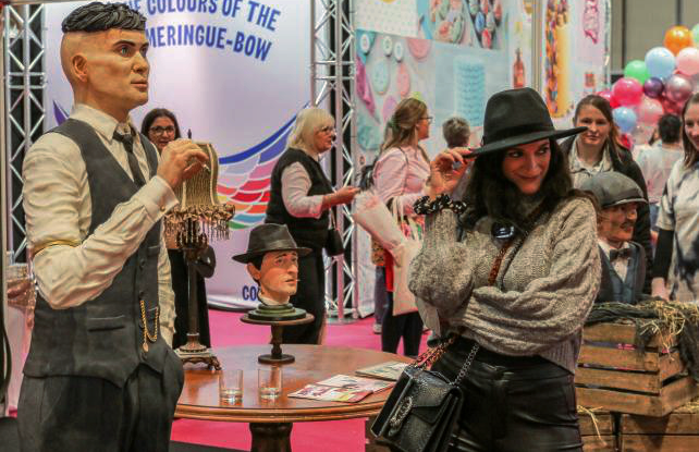 Peaky Blinder fans pose with the life-size cake of Tommy Shelby