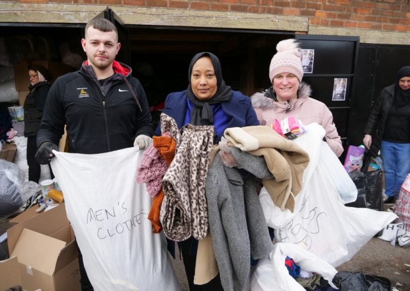 (L-R) Birmingham volunteers Antony Hughes, Hiba Babiker and Jo Bagby help collect and sort clothes for earthquake victims