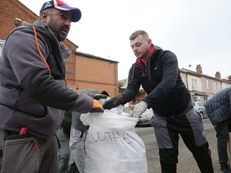 Volunteers Ayaz Anwari (left) with friend Anthony Hughes help pack warm clothes for victims of the Turkey-Syria earthquake 