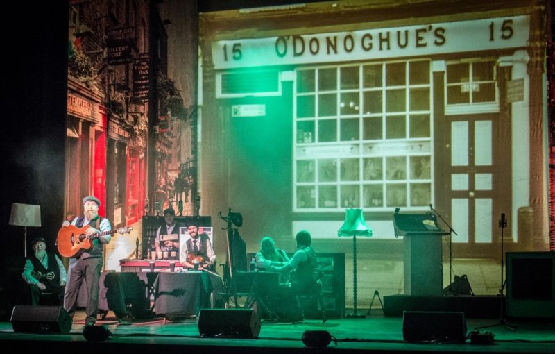 Archives pictures are projected onto the stage to illustrate the story of The Dubliners