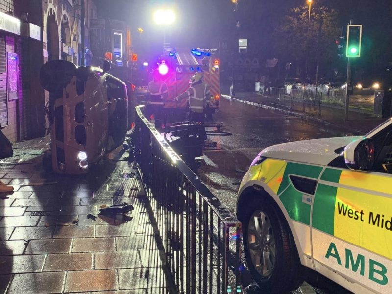 The car crashed through railings and landed on its side on the pavement