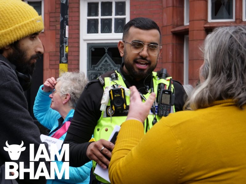 A West Midlands Police officer speaks to local residents in York Road in Kings Heath, Birmingham