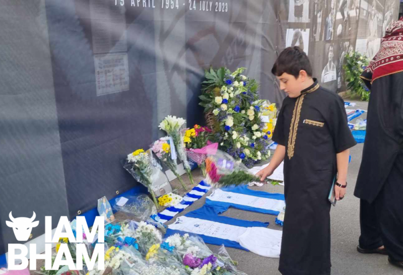 A young fan leaves a floral tribute to Francis outside St Andrews