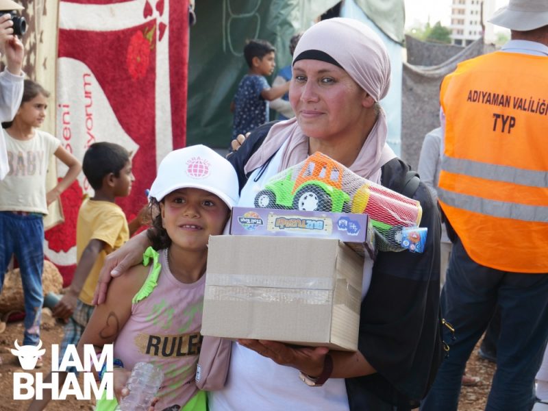 Kheira Mohammed from Birmingham hands out toys to celebrate Eid in the refugee camp