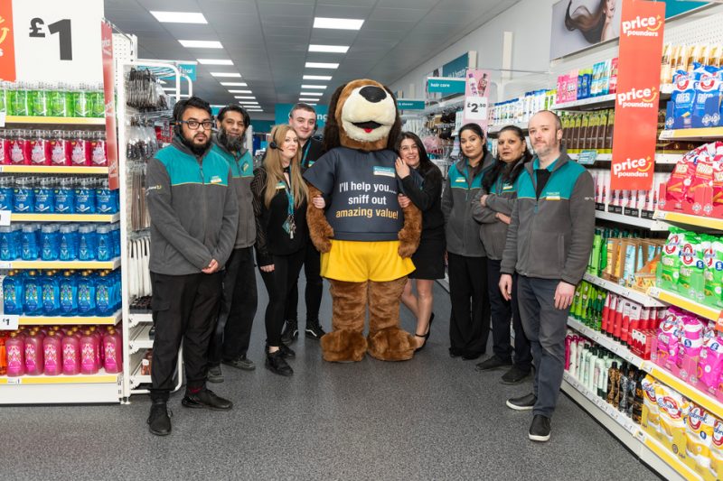 Staff at the new Poundland store alongside brand mascot Pound Hound 