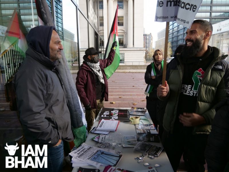 Salman Mirza speaks with an attendee at a Gaza Ceasefire protest in Birmingham  