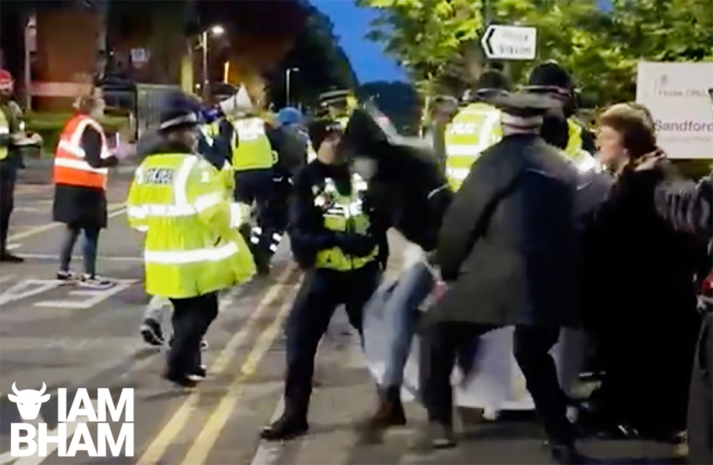 Protesters being arrested outside a Home Office reporting centre in Solihull by West Midlands Police officers